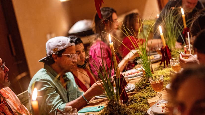 A candlelit dinner table with guests
