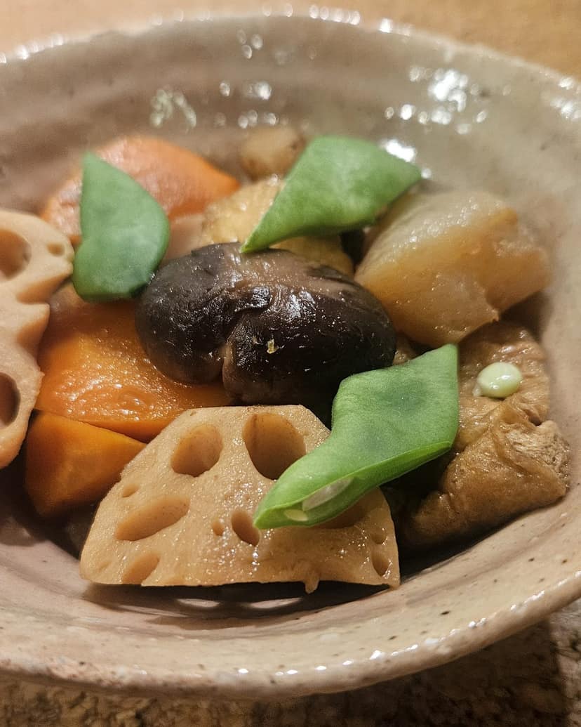 Simmered lotus root, taro and vegetables in a ceramic bowl