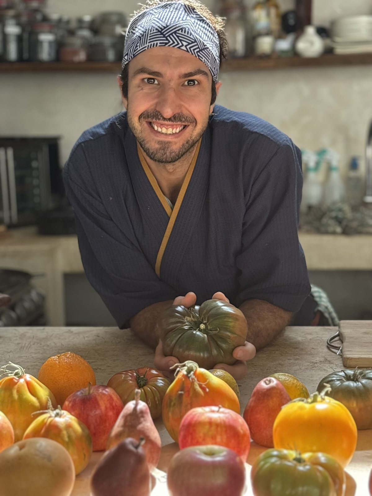 Chef Elliot holding an heirloom tomato