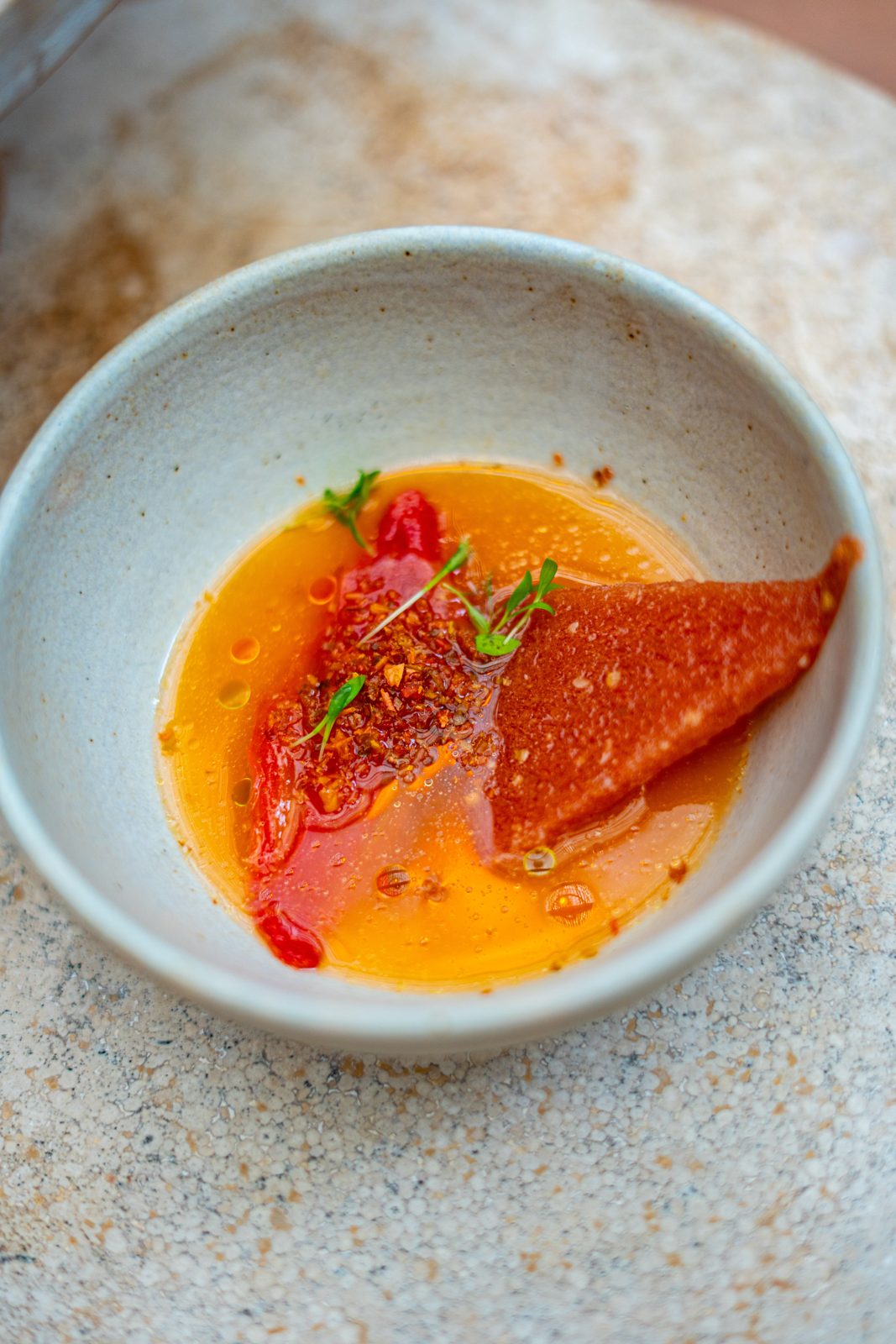 Fish crudo in a citrus broth