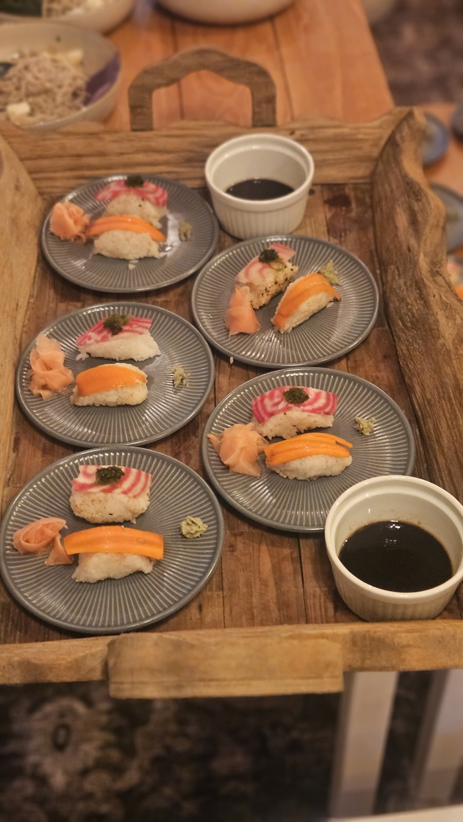 Beet and carrot nigiri on a wooden tray at the Kona kitchen