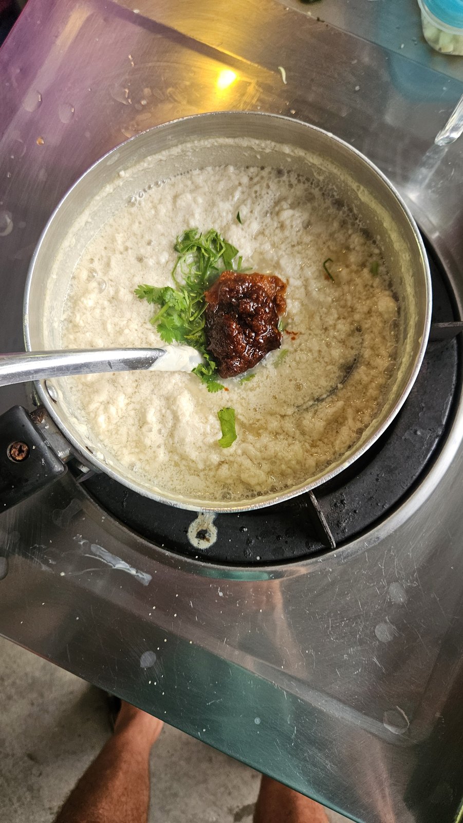 Coconut cream cracking in the pot, chili paste going in