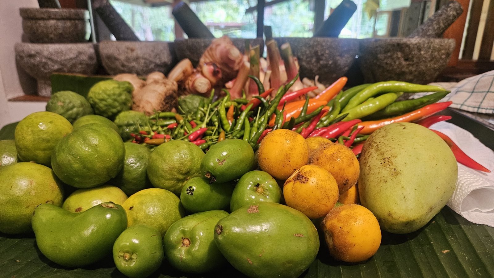 Limes, green mangoes, chilies and galangal from the morning market
