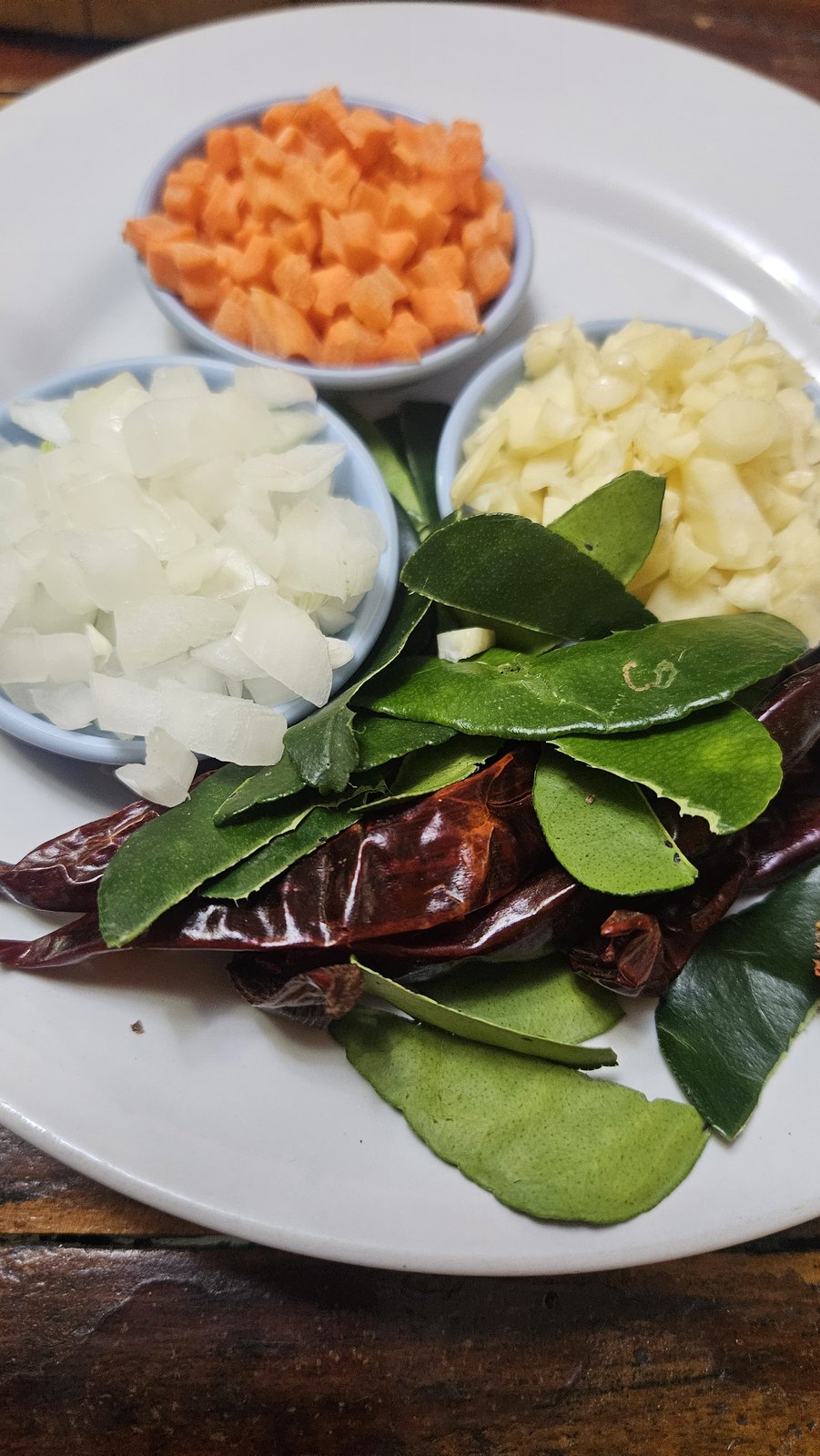 Lime leaves, dried chilies and the prep bowls for a curry paste