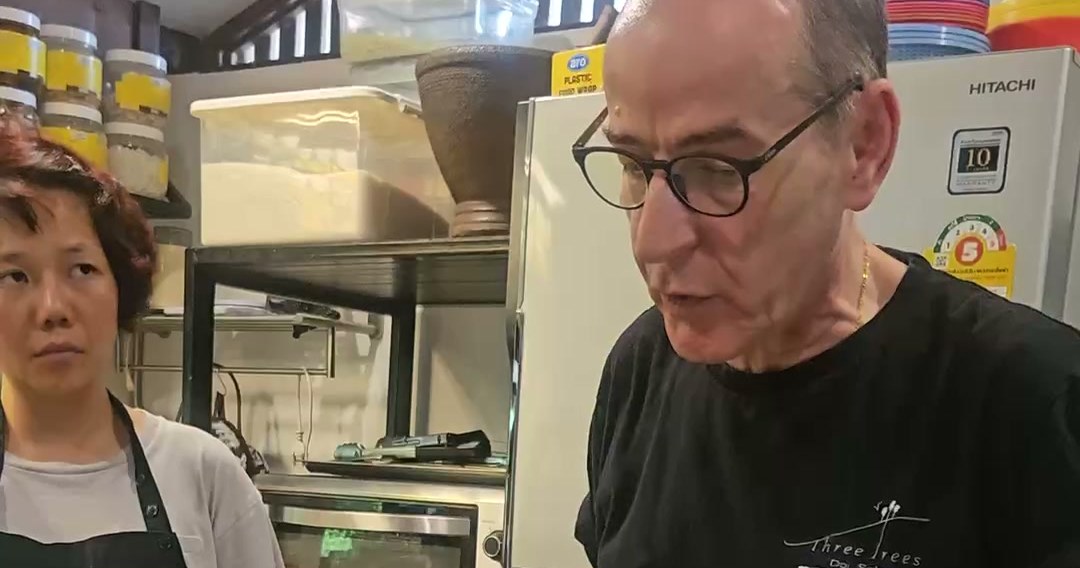 Hanuman Aspler teaching at the prep table in the Three Trees kitchen