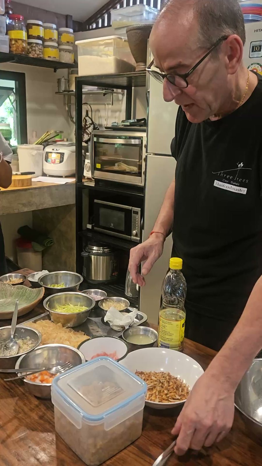 Hanuman Aspler reaching for the bowls on the prep table