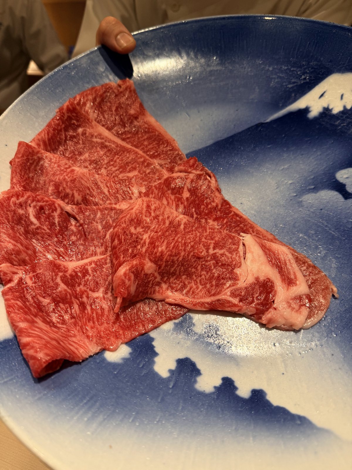 Raw wagyu on the blue plate