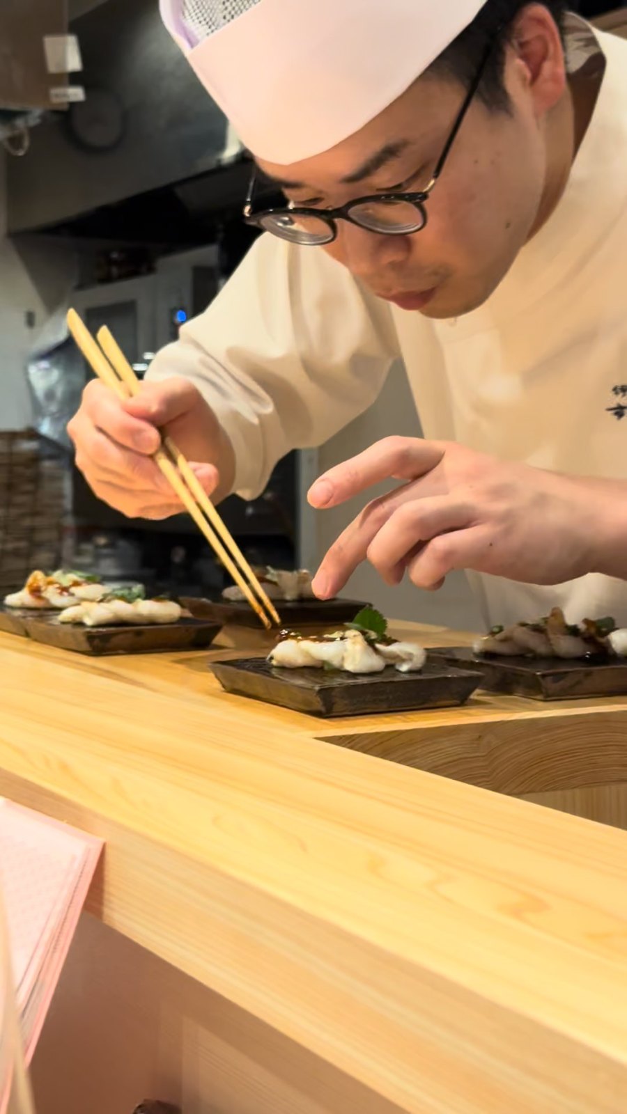 Chef Yuki plating at the pass