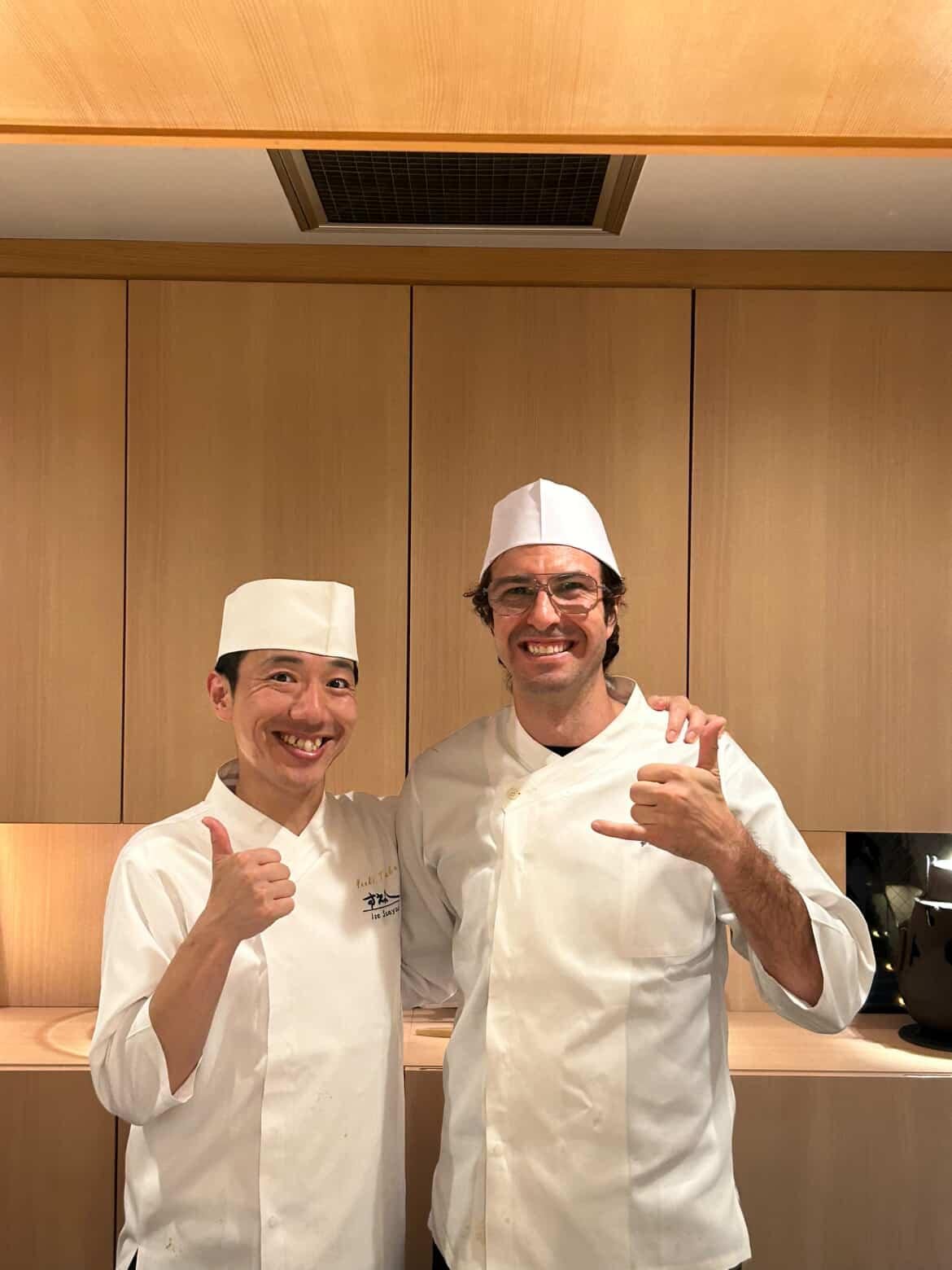 Chef Elliot with Chef Yuki Tanaka in chef whites at Ise Sueyoshi, both giving a thumbs up